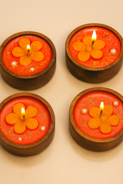 Four wooden candle holders with flower-shaped candles on a beige background